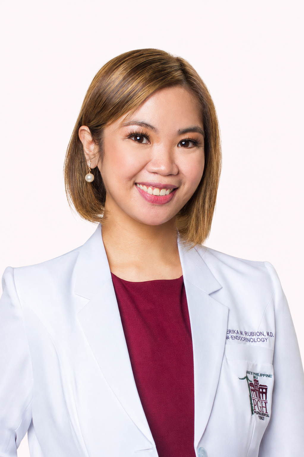 Dr Erika M. Rubion wearing her white medical coat